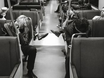 Tired people napping in train