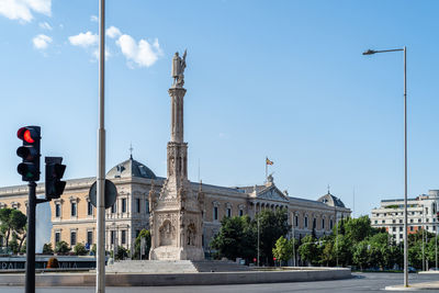 Statue of colon and national library of spain in castellana avenue in madrid.