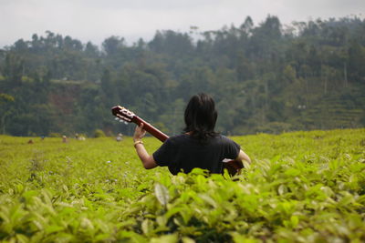 Playing guitar in the tea garden