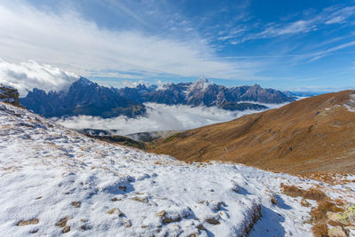 Panorama of pustertal valley covered by clouds with amazing dolomite peaks background, italy