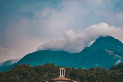 Panoramic view of building and mountains against sky