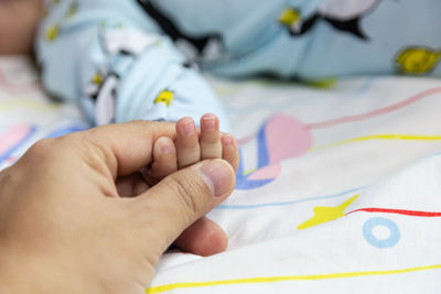 Close-up of boy lying on bed