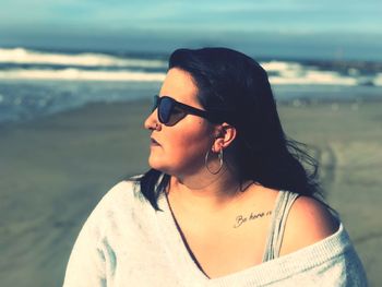 Woman looking away at beach