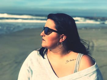 Woman looking away at beach