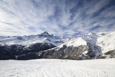 Scenic view of snowcapped mountains against sky