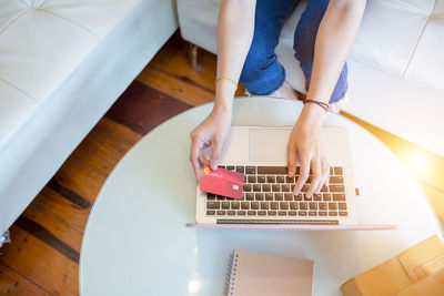 High angle view of woman using laptop on table