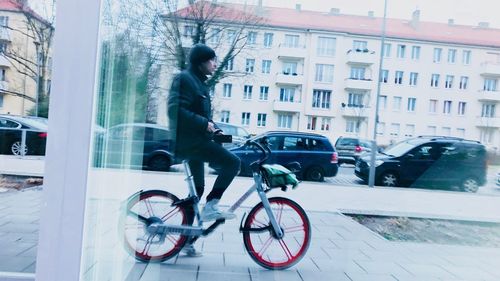 Man with bicycle in city