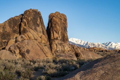 Scenic view of rocky mountains against clear blue sky