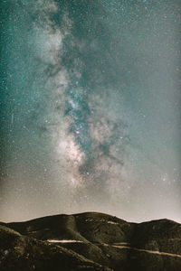 Scenic view of mountains against sky at night