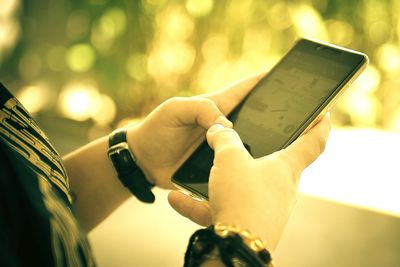 Close-up of man using mobile phone