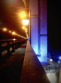 Illuminated underground walkway at night