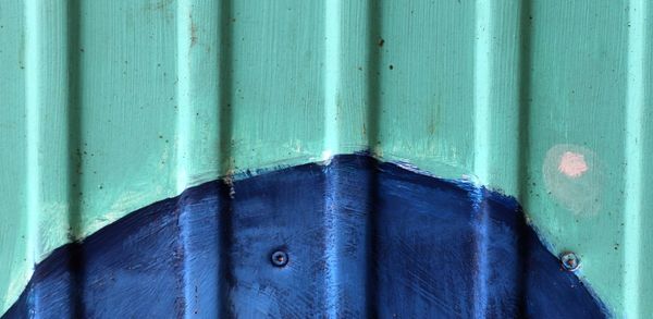 Close-up of blue metal door