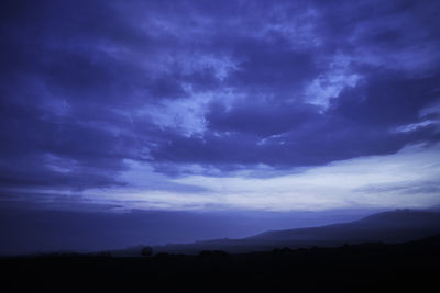 Scenic view of silhouette landscape against sky at sunset