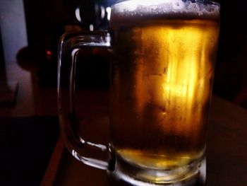 Close-up of beer glass on table