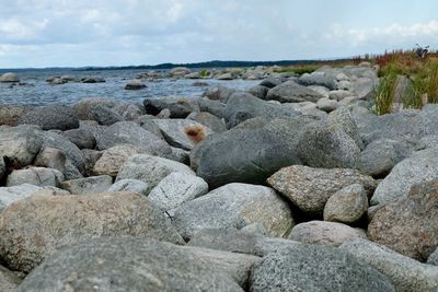 Rocks on beach against sky