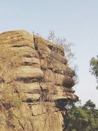 Low angle view of rocks against clear sky