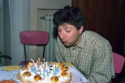 Close-up of boy eating food at home