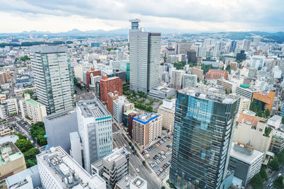 High angle view of modern buildings in city against sky