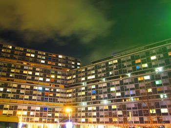 Illuminated cityscape against sky at night