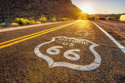 Road sign on street in city during sunset