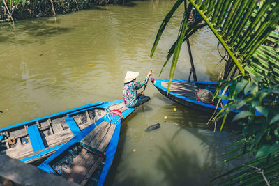 High angle view of man floating on lake