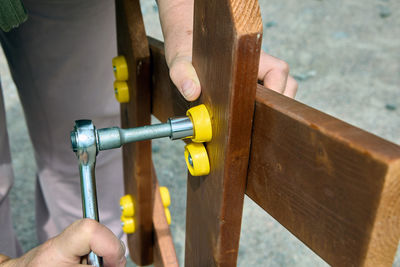 Cropped hand of man working on wood