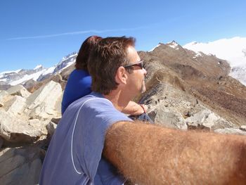 Side view of man on mountain during sunny day