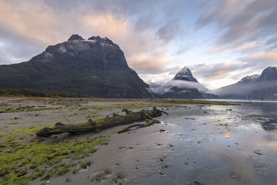 Scenic view of land and mountains against sky