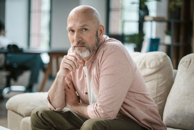 Young man sitting on sofa at home