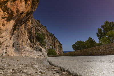 Road by mountain against clear sky