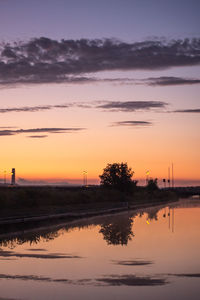 Scenic view of lake against orange sky