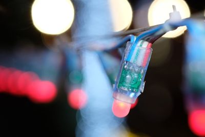 Close-up of hand holding illuminated lighting equipment