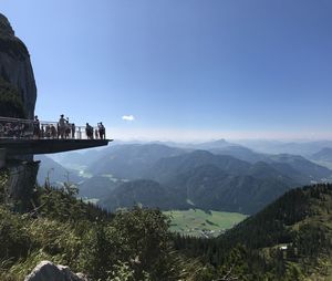 People on mountain against sky