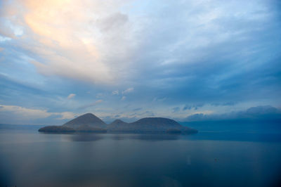 Scenic view of sea against cloudy sky