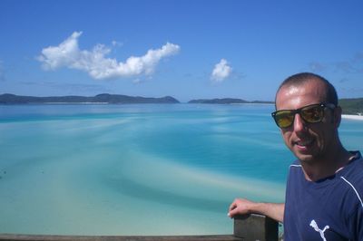 Portrait of smiling man in sea against sky