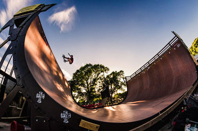 Low angle view of man skateboarding against sky