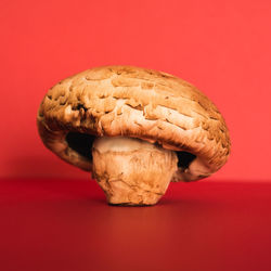 Close-up of bread on table against red background