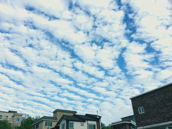 Low angle view of building against cloudy sky