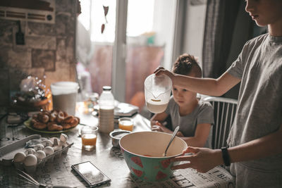 High angle view of girl preparing food on table