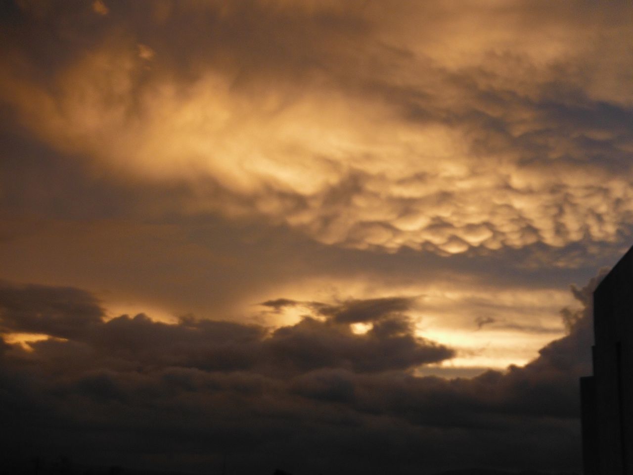 sky, sunset, cloud - sky, low angle view, silhouette, cloudy, cloud, beauty in nature, scenics, nature, built structure, architecture, building exterior, tranquility, dramatic sky, weather, cloudscape, overcast, tranquil scene, dusk