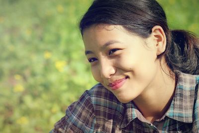 Close-up of smiling young woman looking away