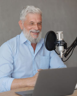 Portrait of senior man using laptop while sitting at home