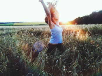Boy on field against clear sky