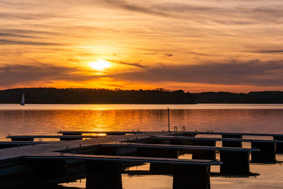 Scenic view of lake against orange sky