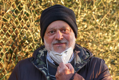 Portrait of man wearing mask standing outdoors