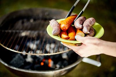 Close-up of hand holding meat