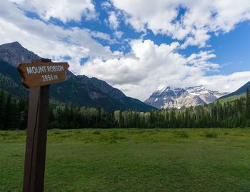 Information sign on landscape against sky