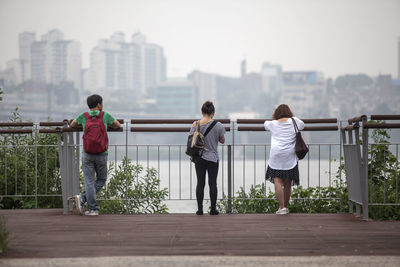 Woman standing on footbridge