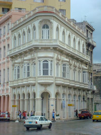 Cars on street by buildings in city