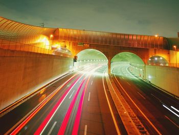 Light trails on bridge in city at night